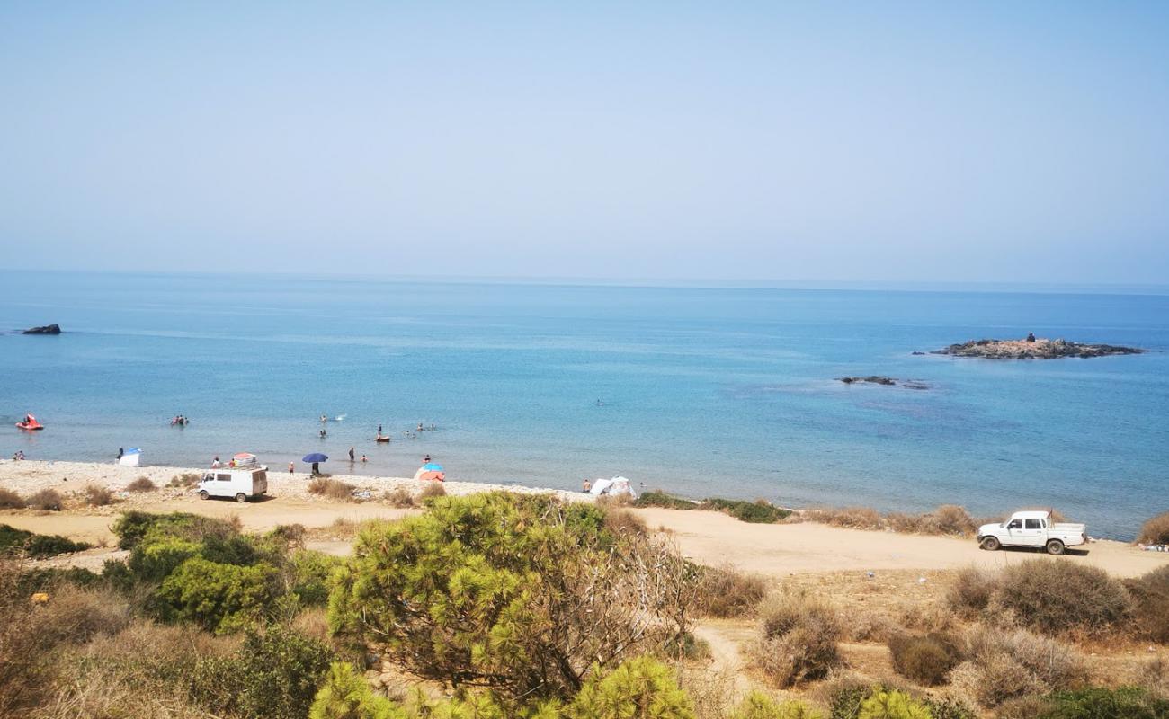 Photo of Adjroud beach with bright sand & rocks surface