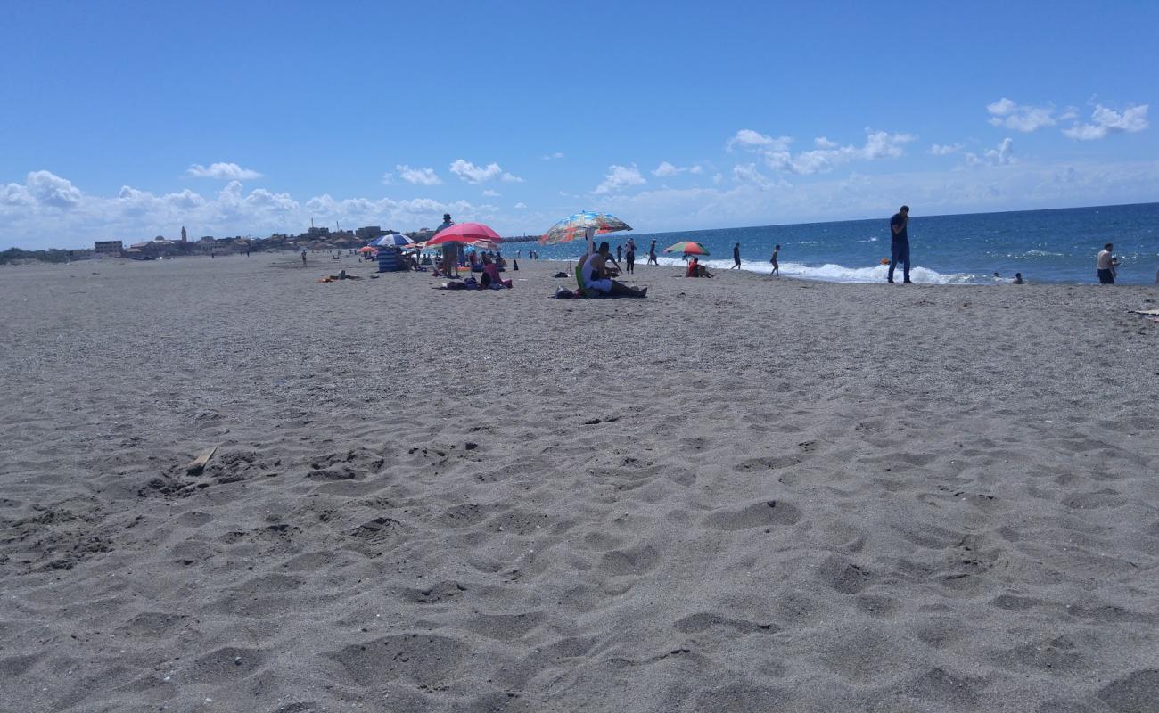 Photo of Plage Adim with gray sand surface