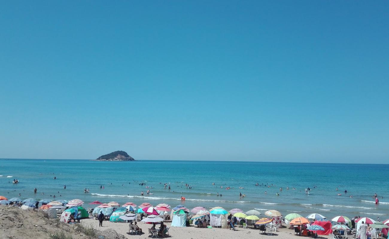 Photo of Awana Beach with bright sand & rocks surface