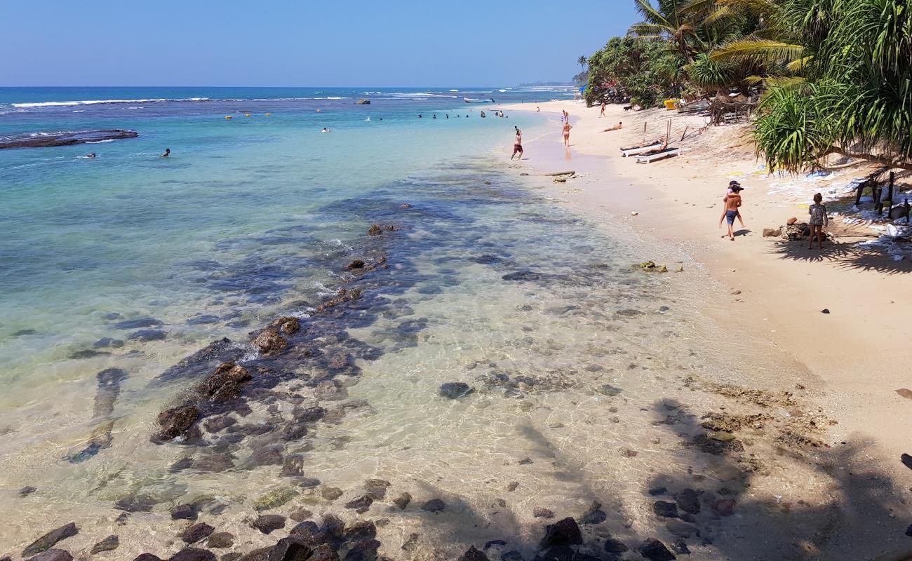 Photo of Madiha Beach with bright sand & rocks surface