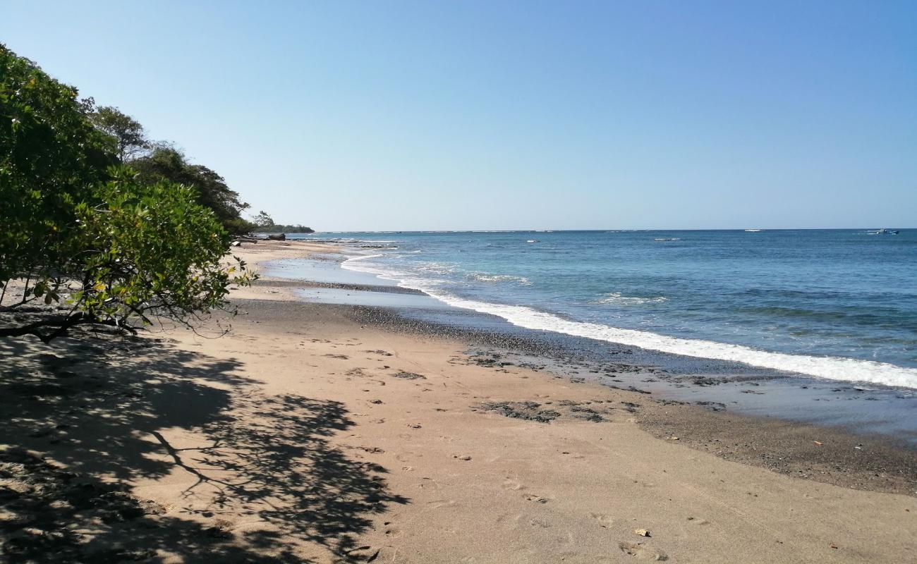 Photo of Playa Lagartillo with bright sand & rocks surface