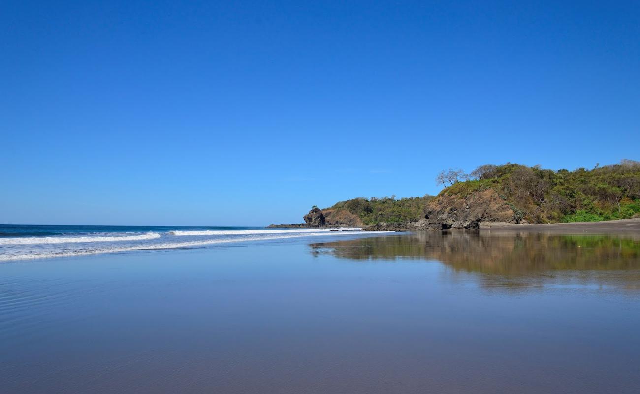 Photo of Ostional Beach with gray sand surface