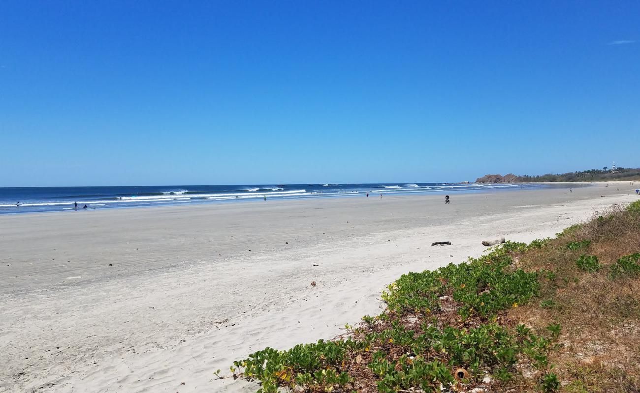 Photo of Playa Guiones with bright sand & rocks surface