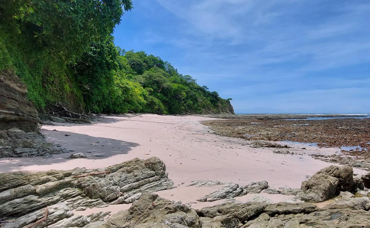 Photo of Playa Rosada with bright sand & rocks surface