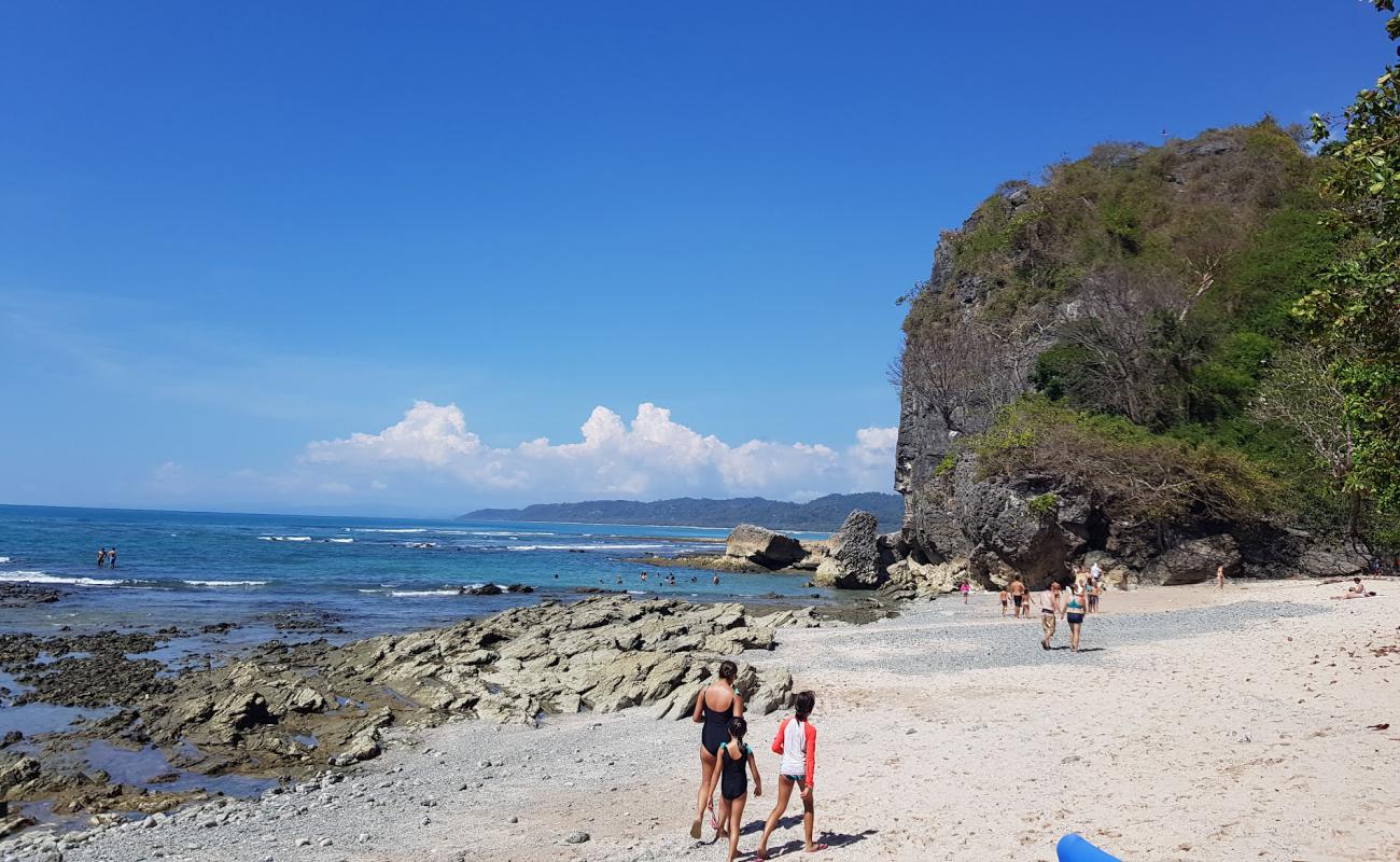 Photo of Playa Cuevas with bright sand & rocks surface