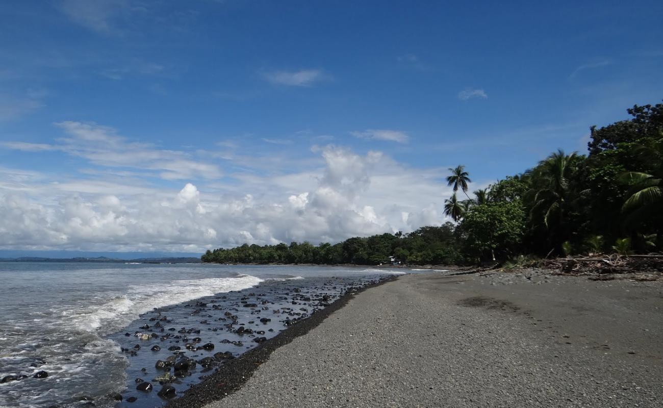 Photo of Playa Pavones with brown pebble surface