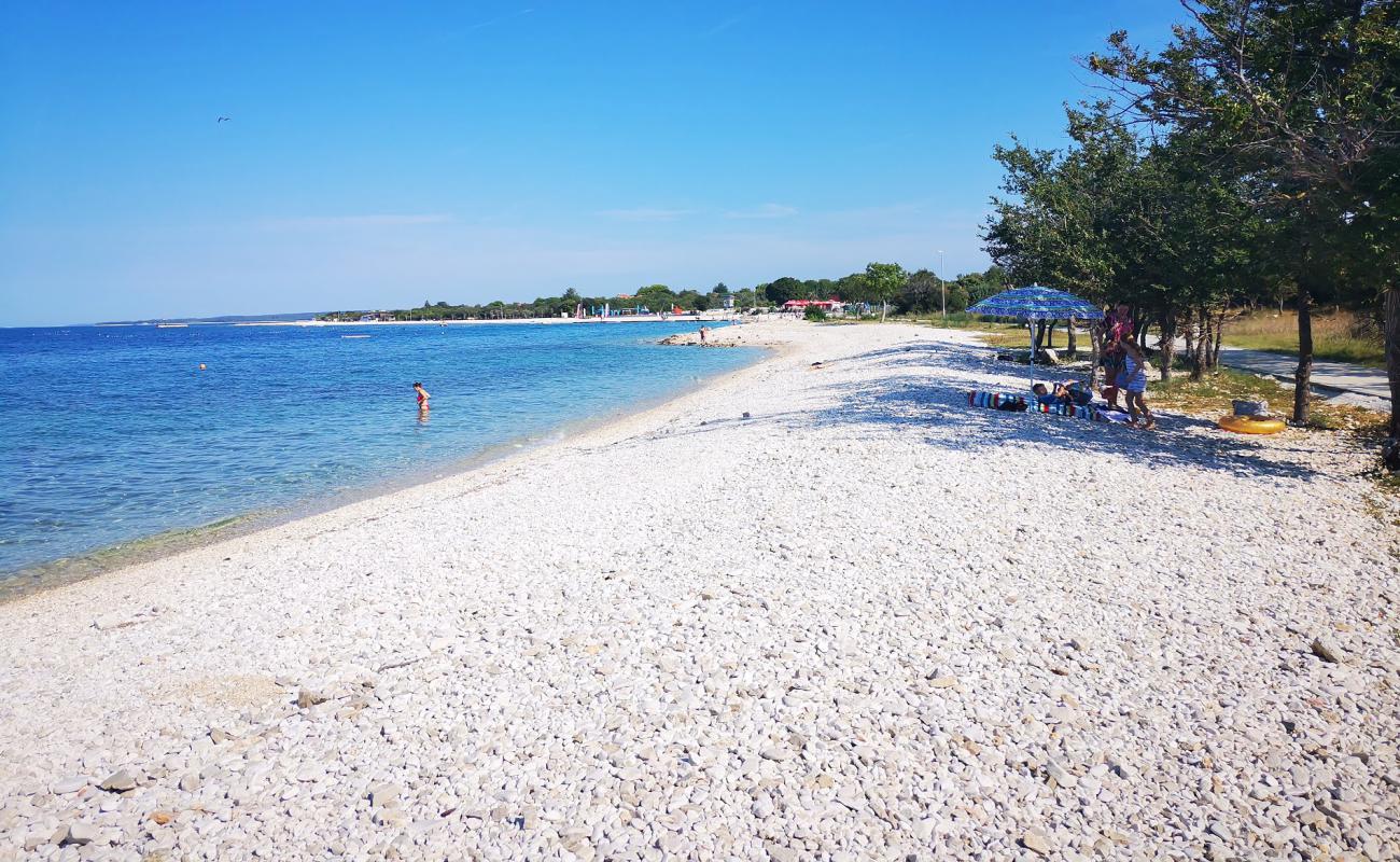 Photo of Pebble beach with white pebble surface