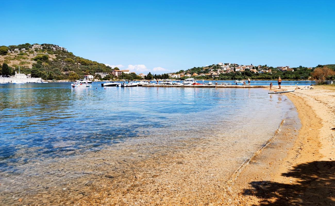 Photo of Przina Beach with bright sand & rocks surface