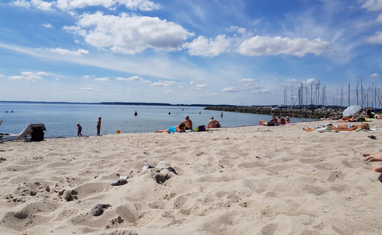 Photo of Den Sorte Beach with bright sand surface