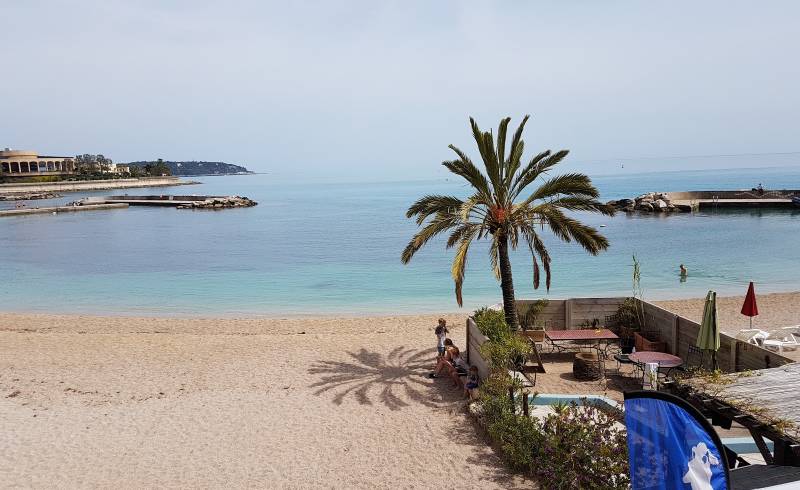 Photo of Larvotto Beach with light fine pebble surface