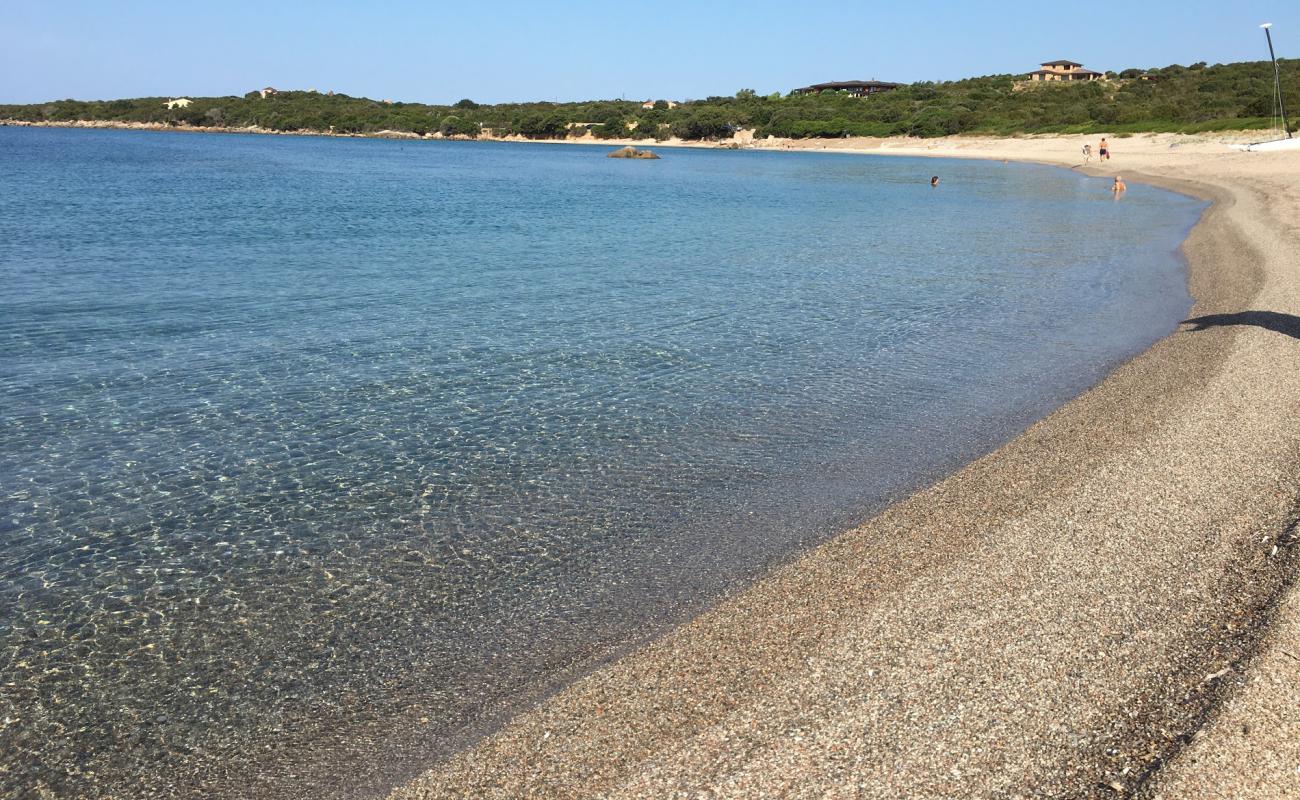 Photo of Figari beach with bright sand & rocks surface