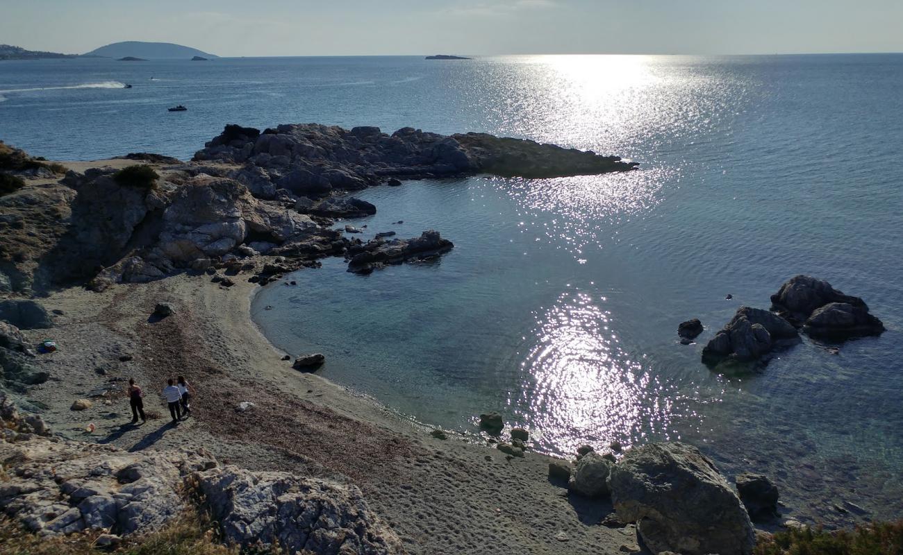 Photo of Paralia Kolpiskos with brown sand &  rocks surface