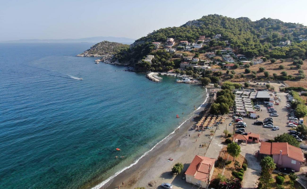 Photo of Paralia Perani with brown sand &  rocks surface