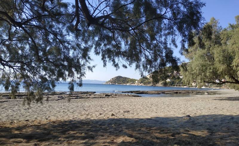 Photo of Paralia Perani II with brown sand &  rocks surface