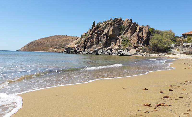 Photo of Myrina beach with brown sand surface