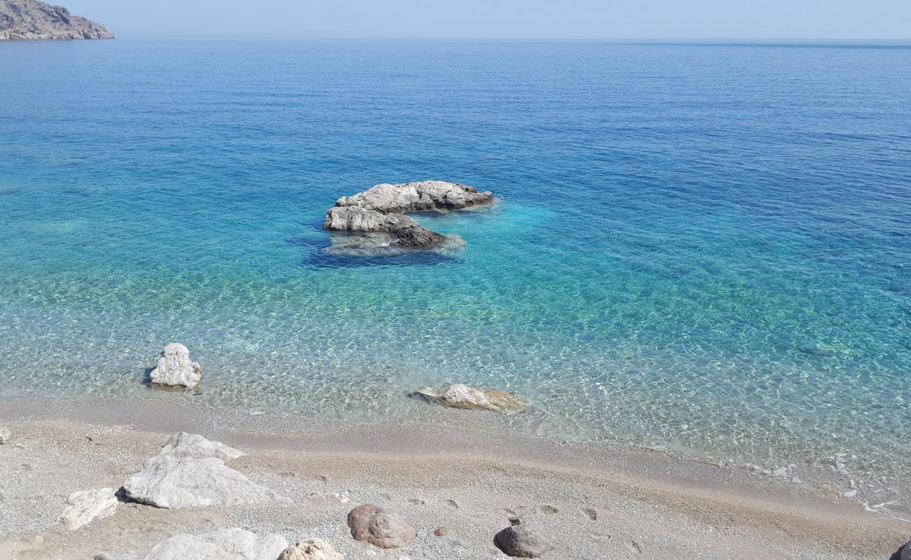 Photo of Evangeline beach with bright sand & rocks surface