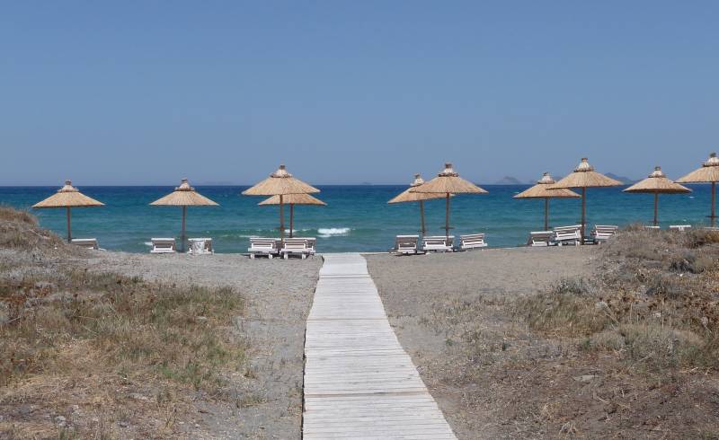 Photo of Blue lagoon beach with gray sand surface