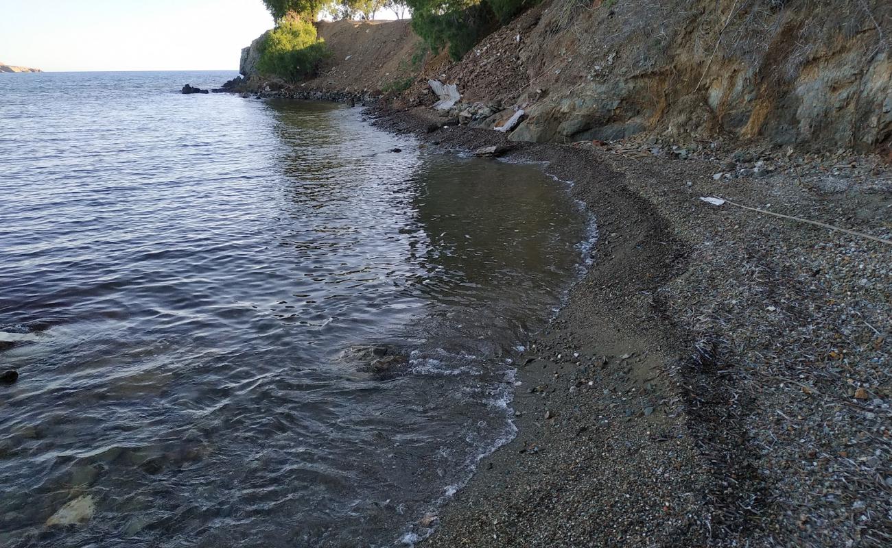 Photo of Paralia Agios Isidoros with gray sand &  rocks surface