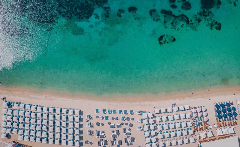 Photo of Ornos beach with bright fine sand surface