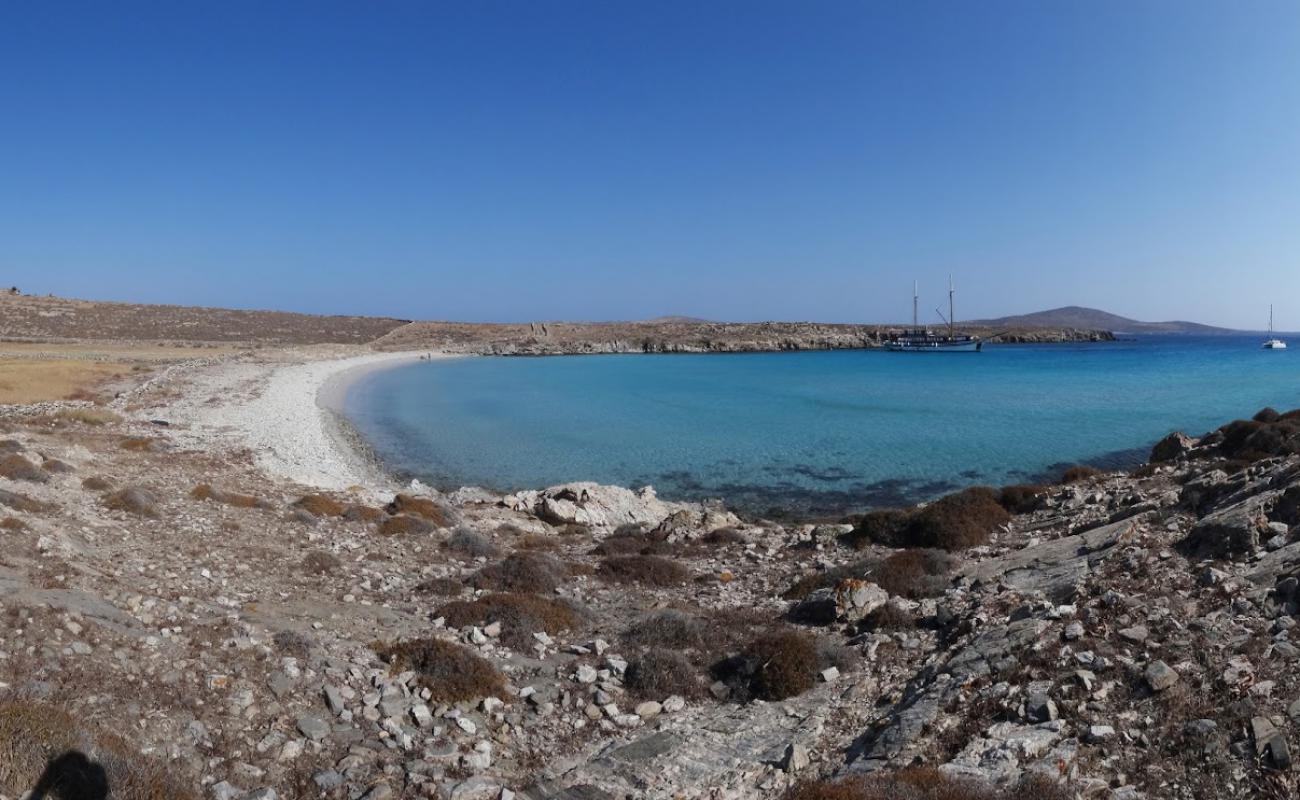 Photo of lygias beach with bright sand & rocks surface