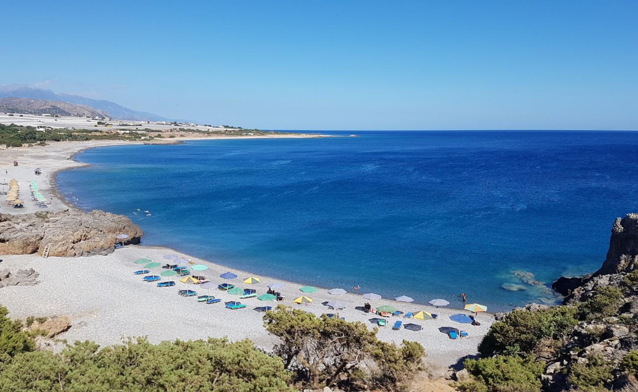 Photo of Krios Beach with gray pebble surface