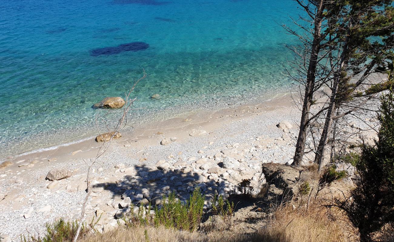 Photo of Afales beach with bright sand & rocks surface