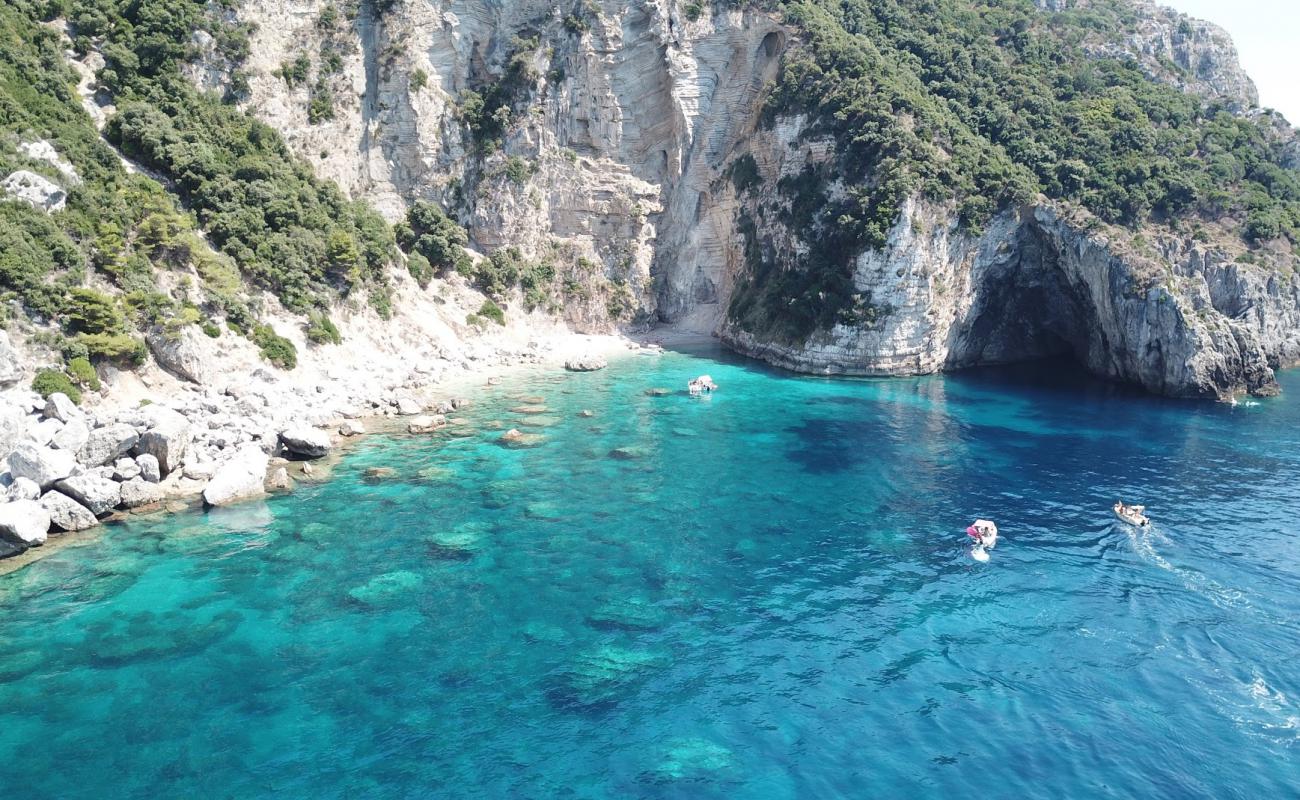 Photo of Krouza beach with bright sand & rocks surface