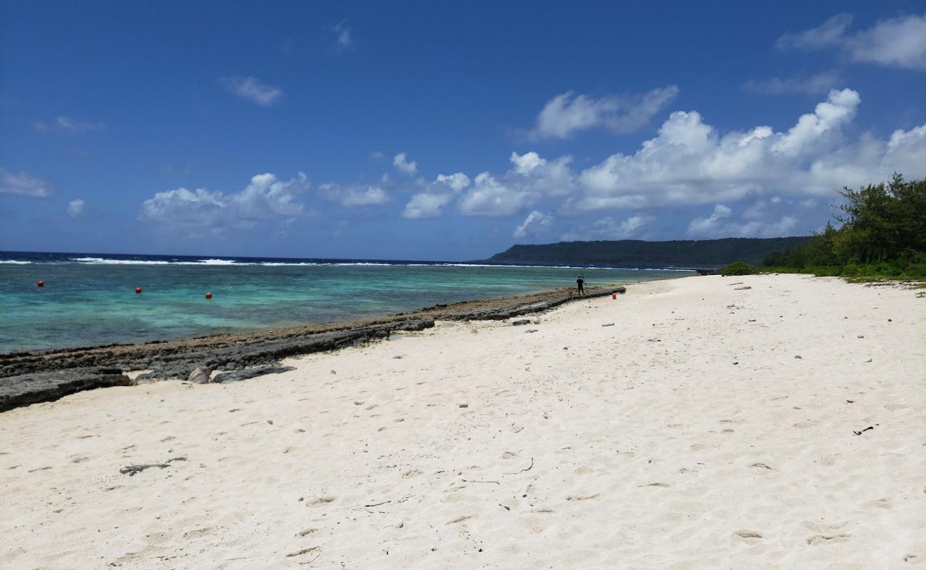 Photo of Tarague Beach with bright sand & rocks surface