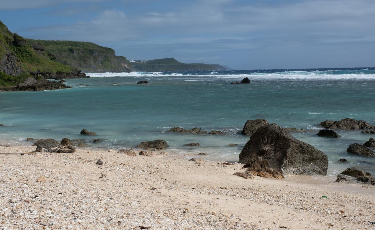 Photo of Taga'chang Beach with bright sand & rocks surface