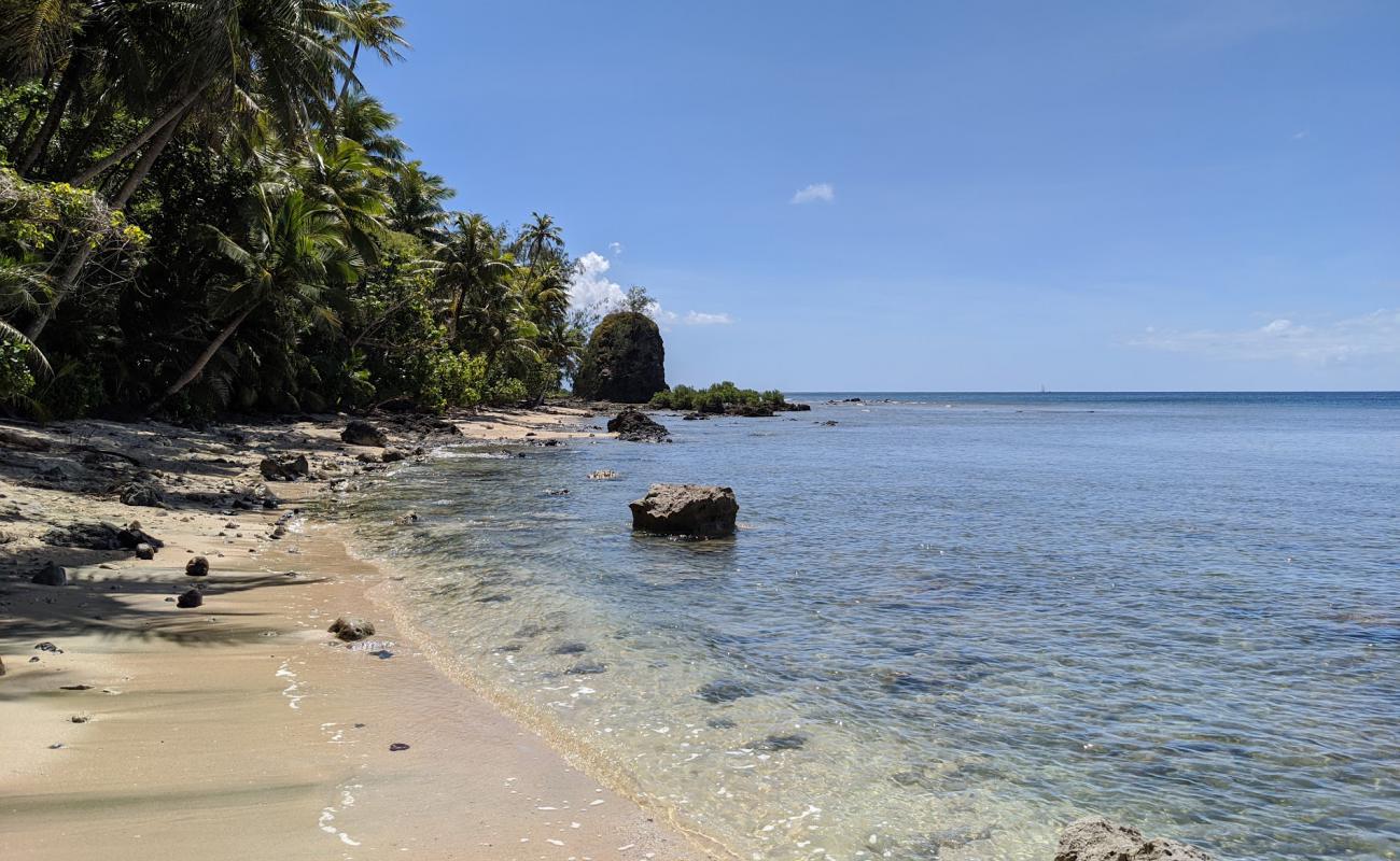 Photo of Sella Bay with gray sand &  rocks surface