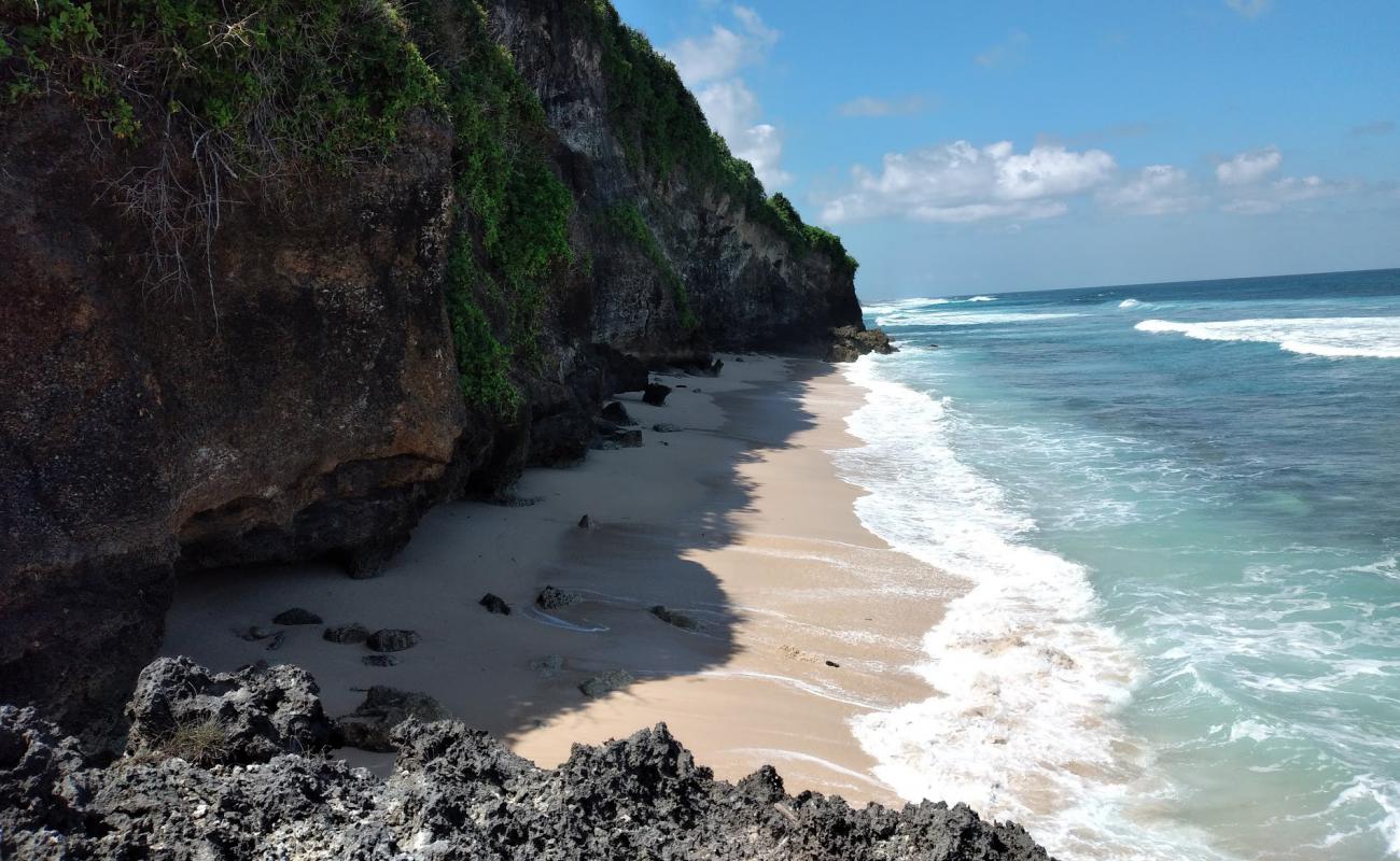 Photo of Alila Uluwatu Beach with bright sand & rocks surface