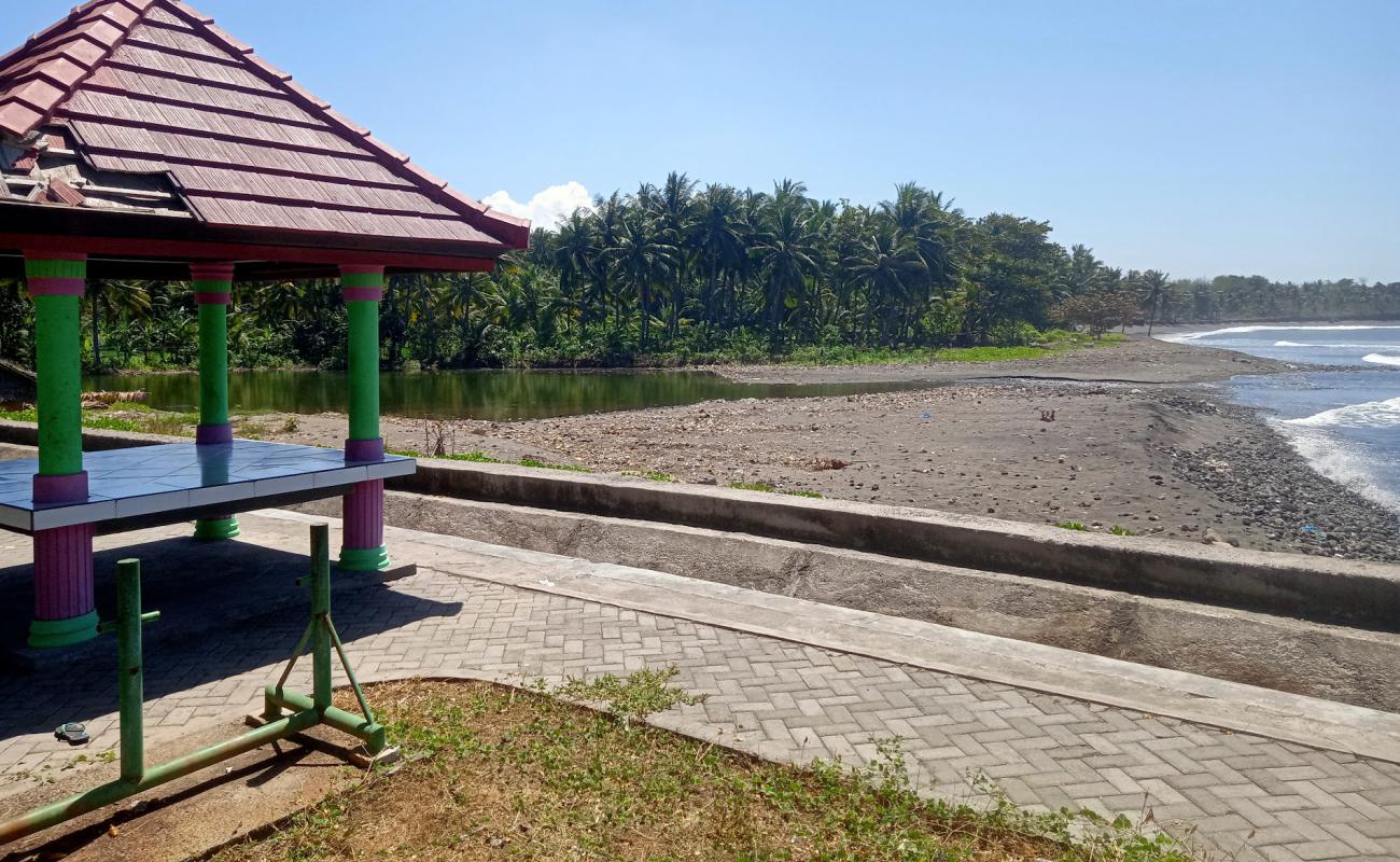 Photo of Dharmawangi Beach with black sand & pebble surface