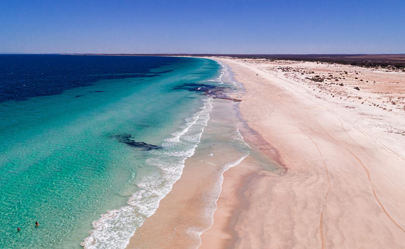 Photo of Mills Beach with bright sand surface