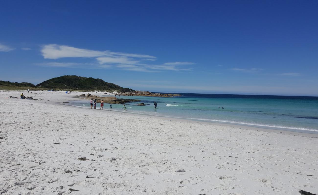 Photo of Jeanneret Beach with white sand surface