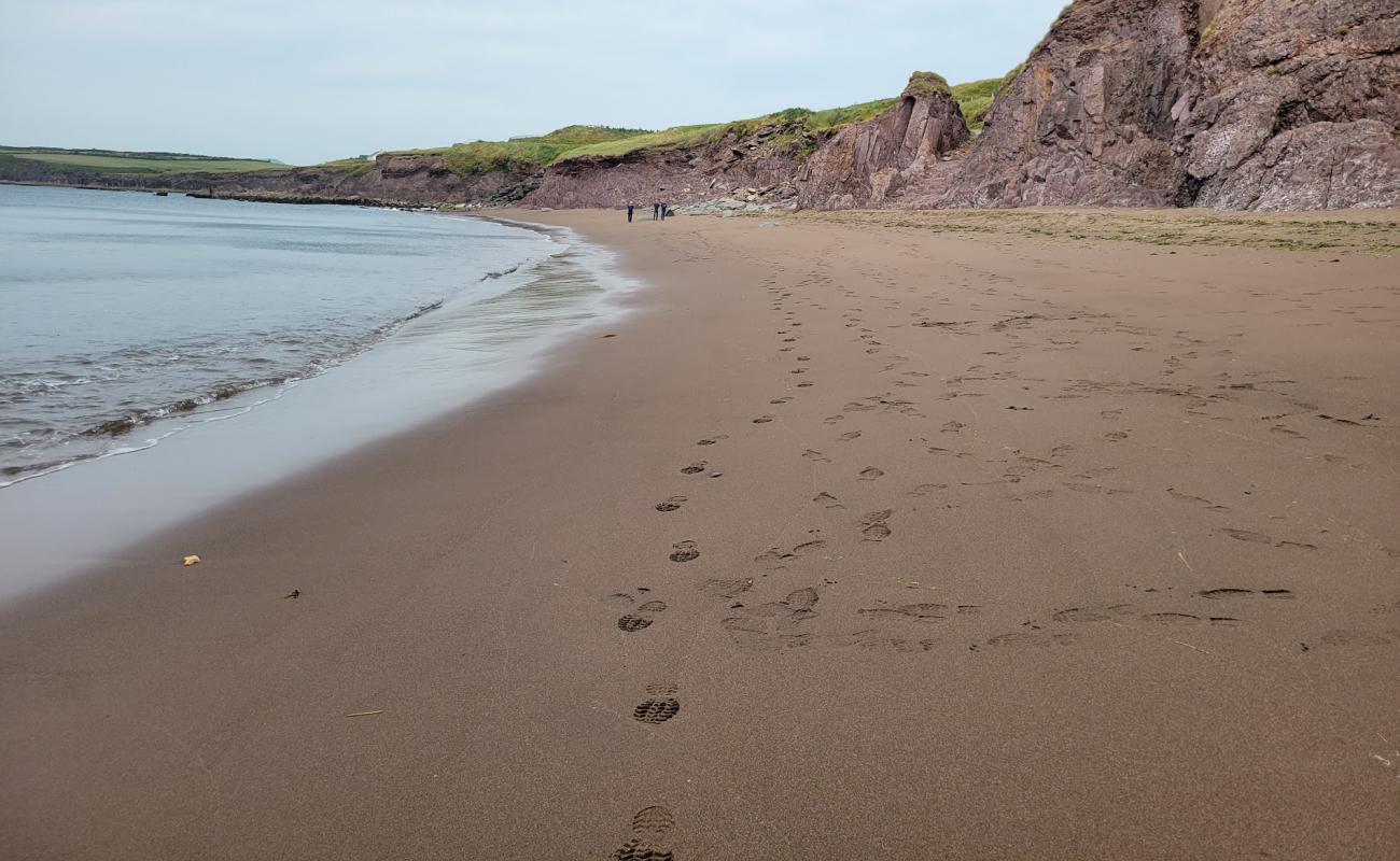 Photo of Kinard Beach with bright sand & rocks surface