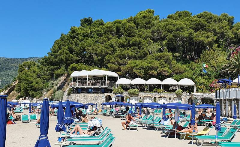 Photo of Andora beach III with gray sand &  rocks surface