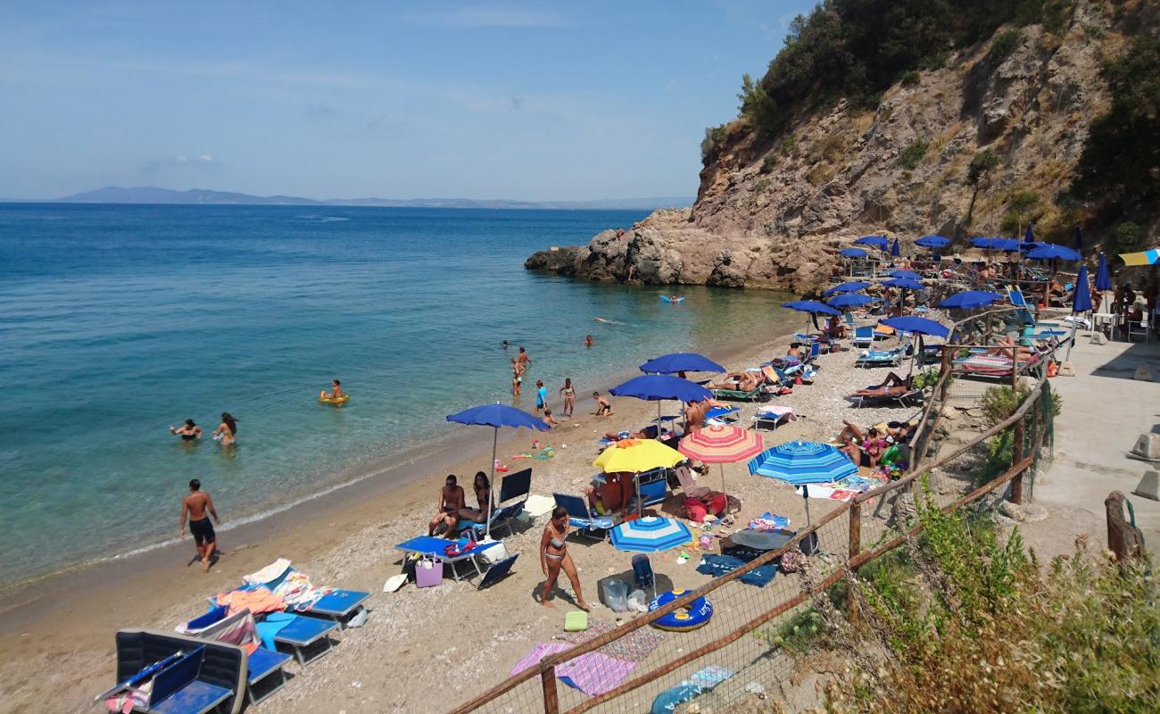 Photo of Spiaggia La Cantoniera with brown fine pebble surface