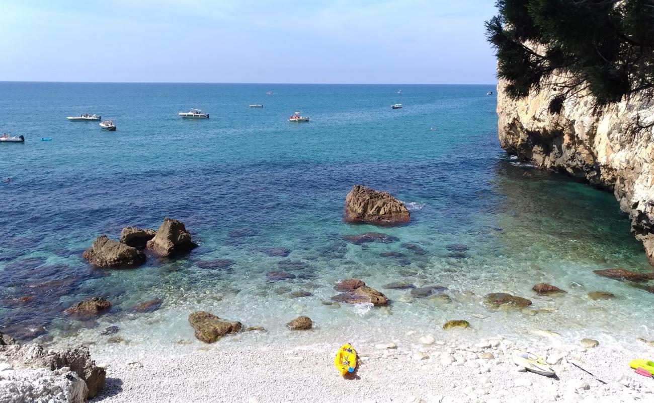 Photo of Spiaggia Dei Prigionieri with gray pebble surface