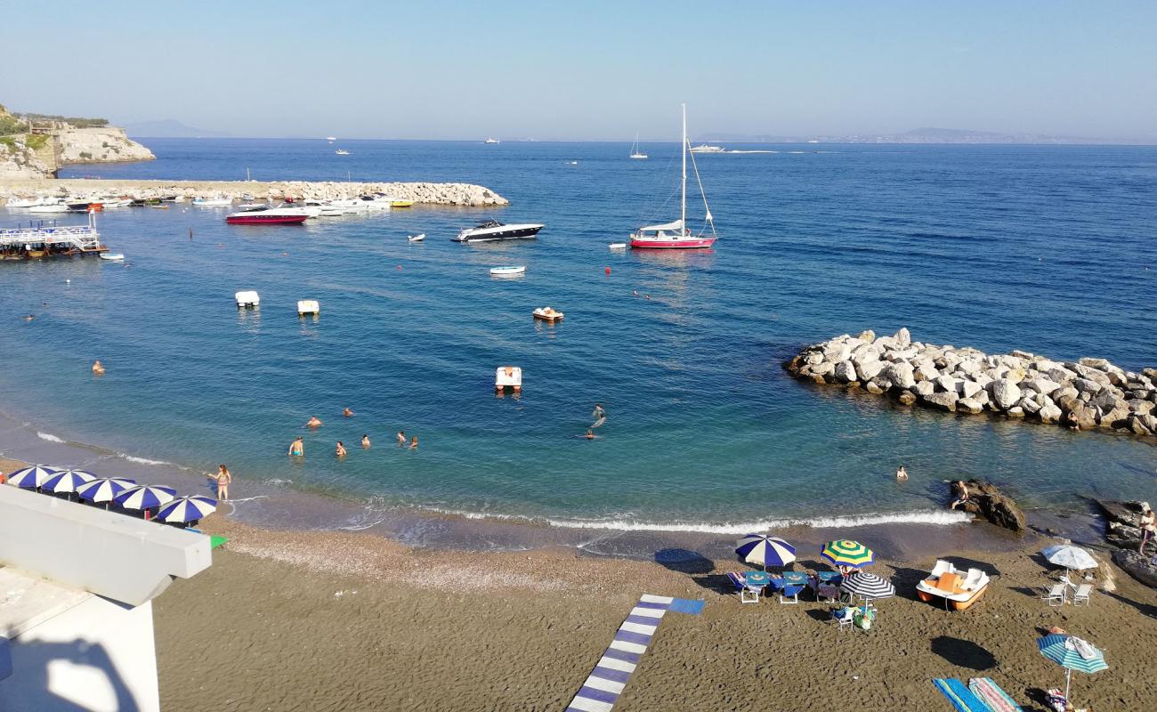 Photo of Cala Di Puolo with gray sand &  pebble surface