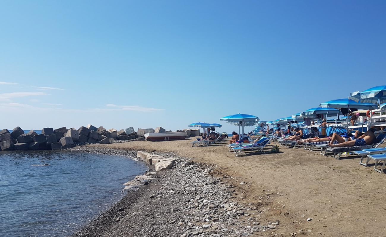 Photo of Bussentino port beach with brown pebble surface