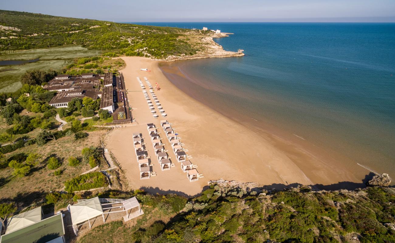 Photo of Baia del Gusmay with brown fine sand surface