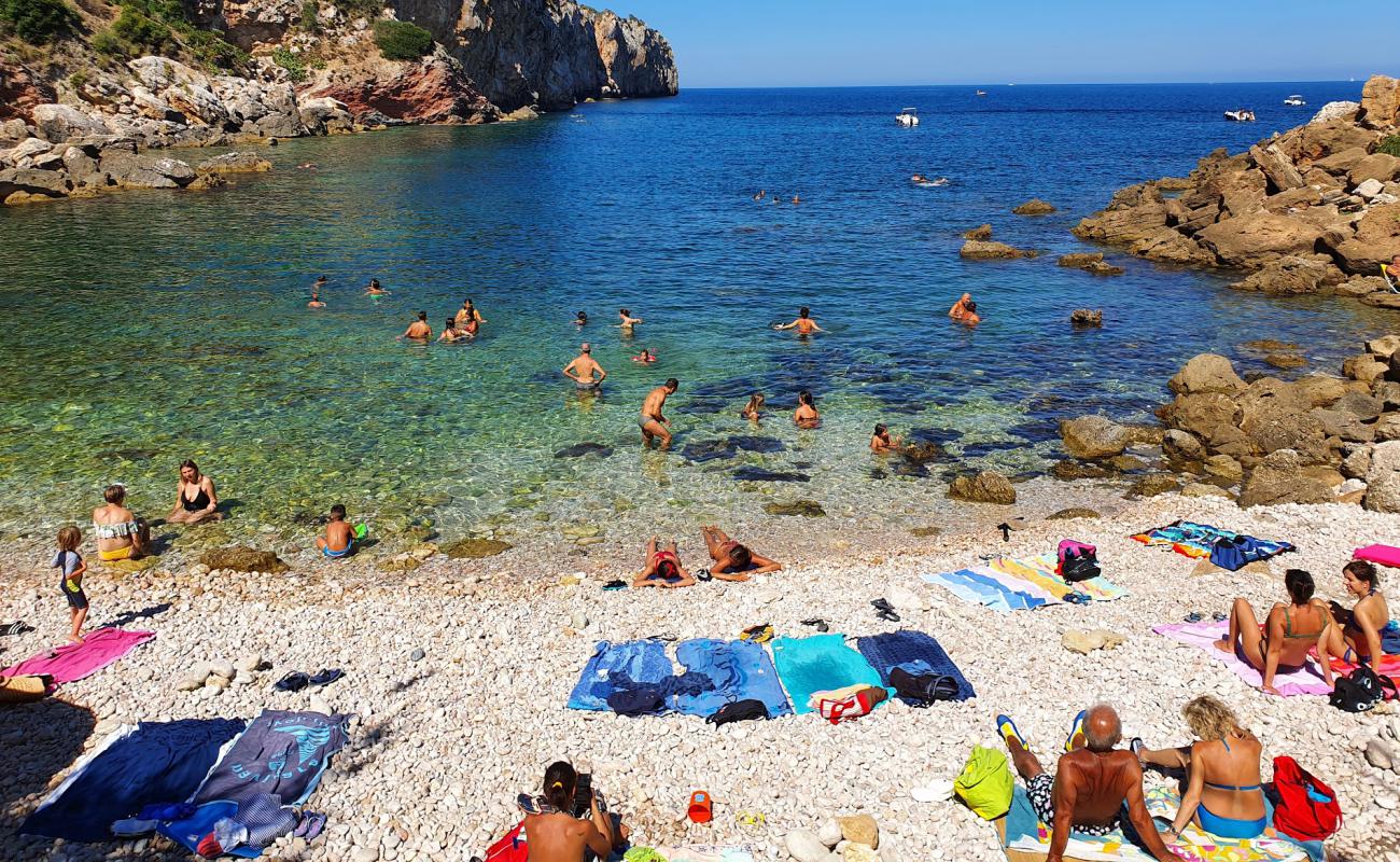 Photo of Cala Rossa with white pebble surface