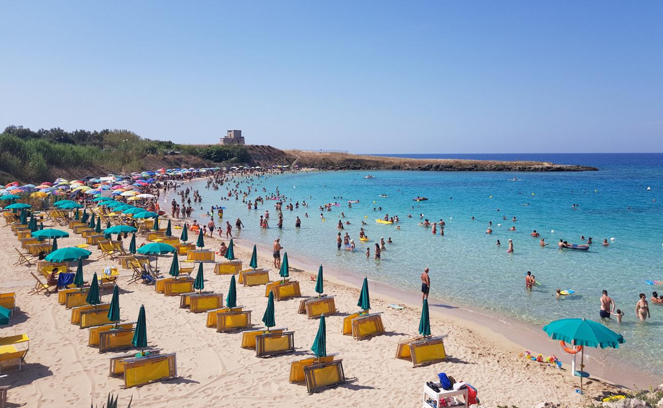 Photo of Canneto beach with brown sand surface