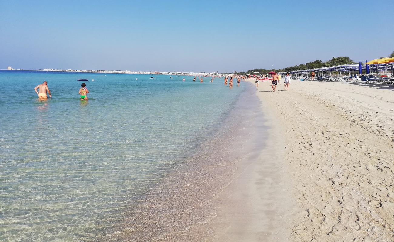 Photo of Spiaggia di Torre Lapillo with bright fine sand surface