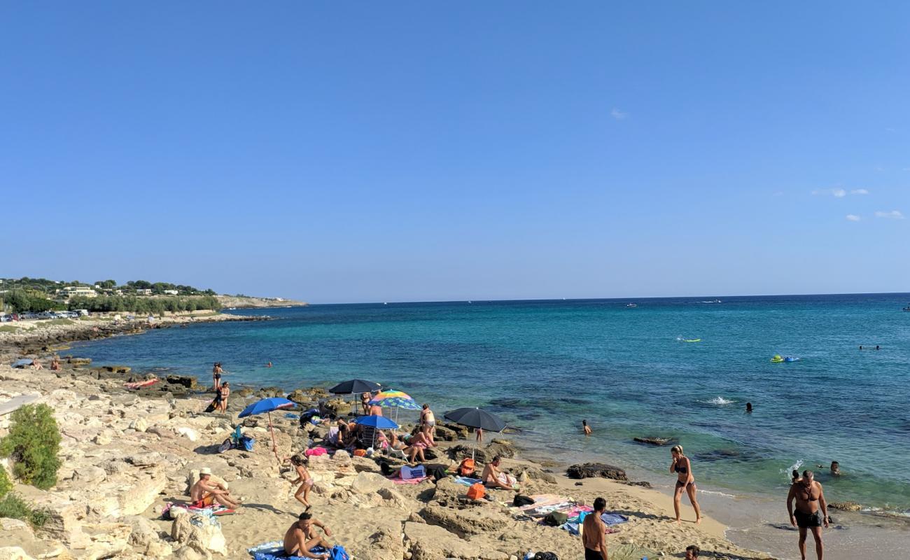 Photo of Felloniche Spiaggia with bright sand & rocks surface