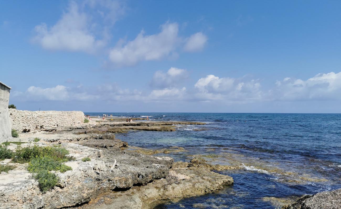 Photo of Libera blue wings beach with gray sand &  rocks surface