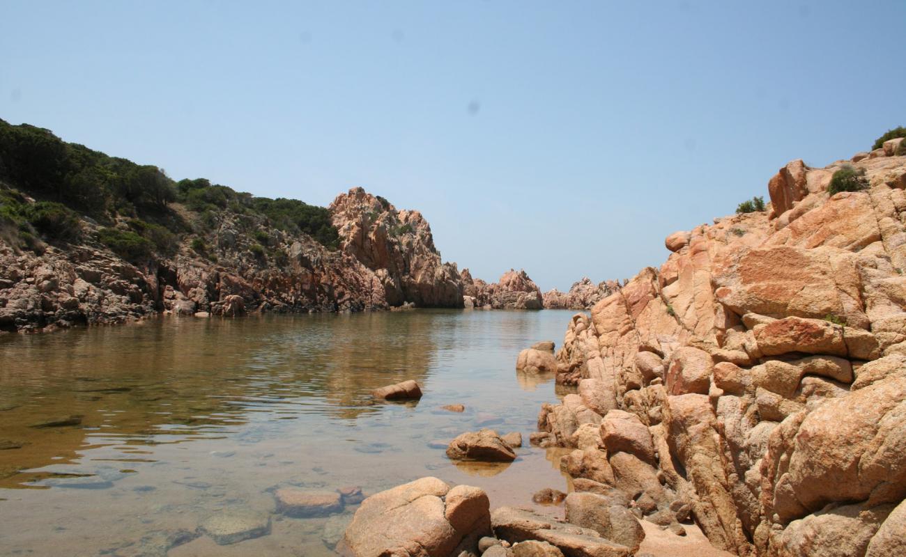 Photo of Porto La Cruzitta with brown sand &  rocks surface