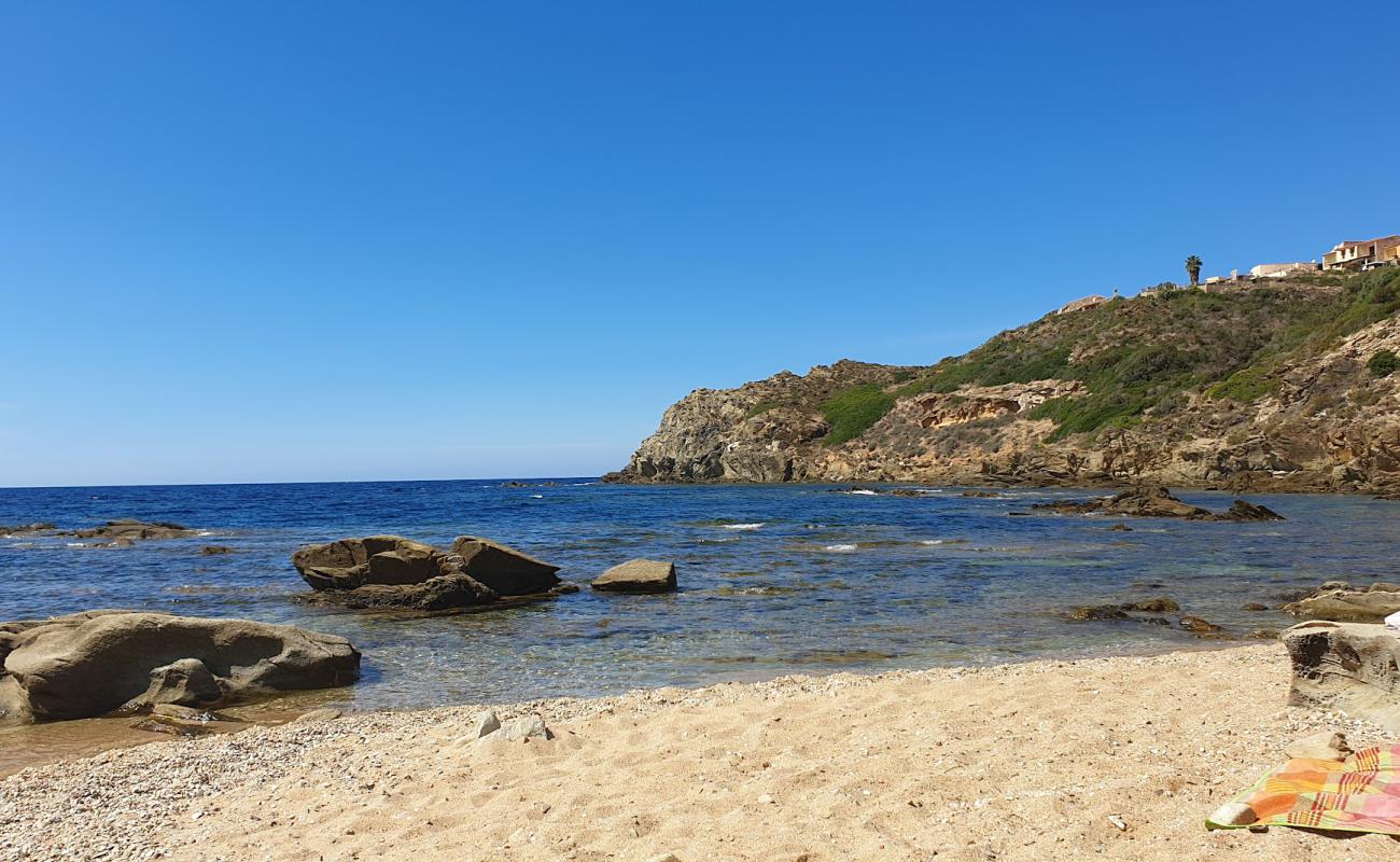 Photo of Cala Is Cannisonis with bright sand & rocks surface