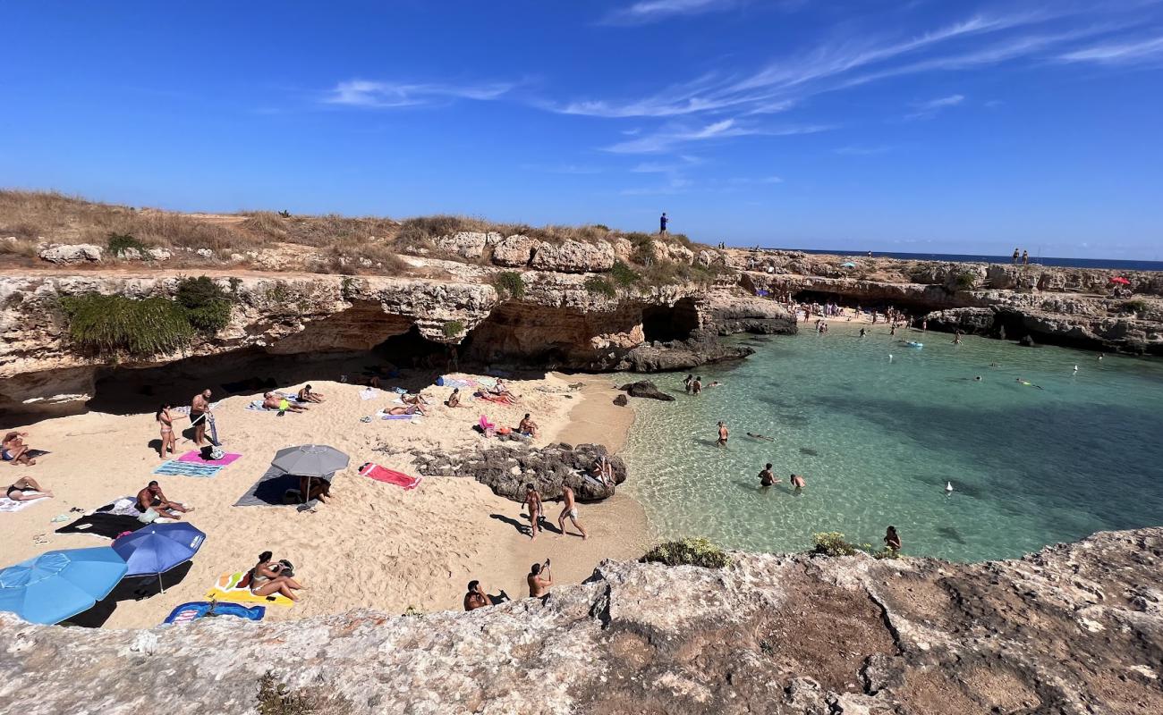 Photo of Grotta della Cala Tre Buchi with bright sand surface