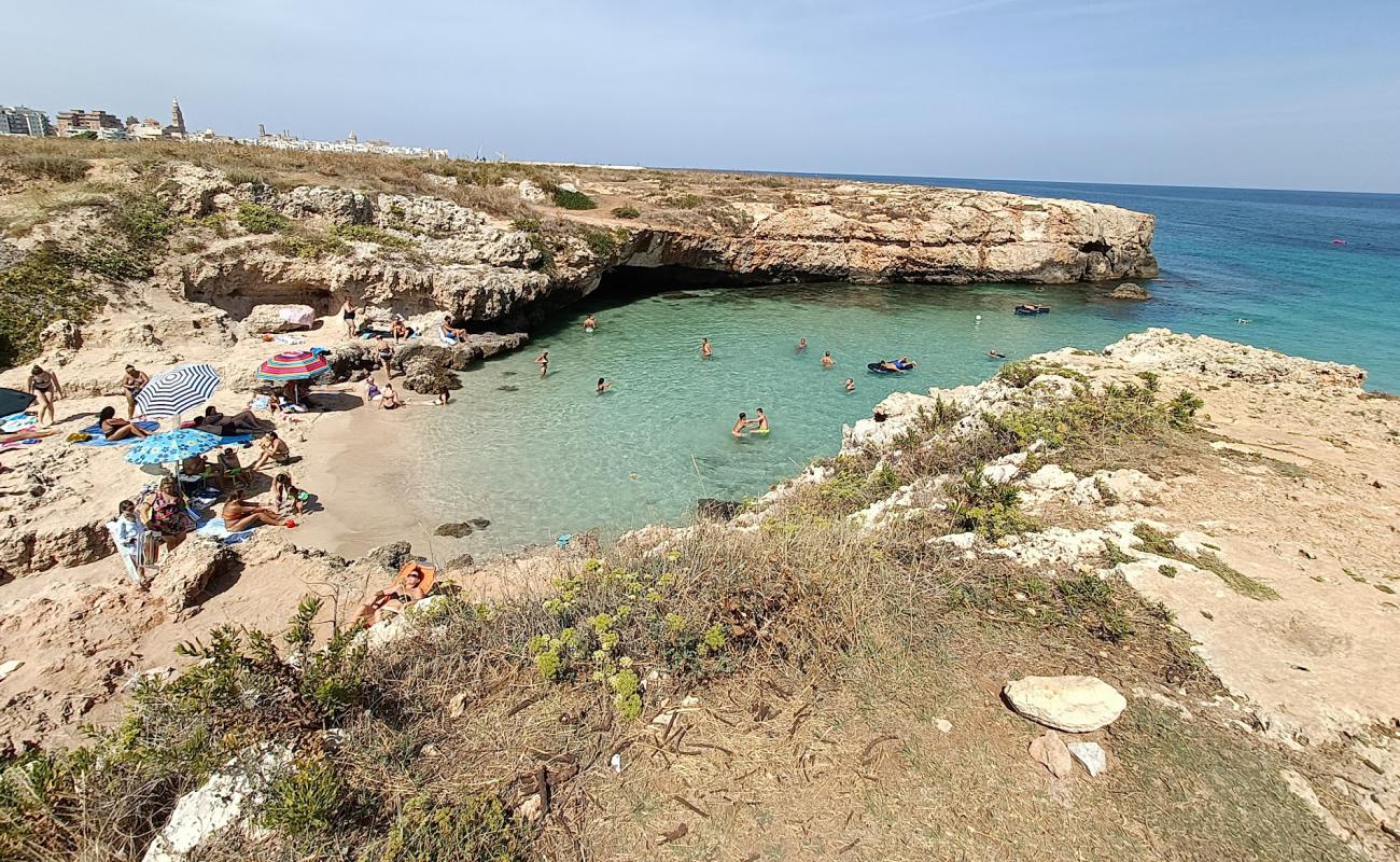 Photo of Spiaggia di Porto Verde with bright sand surface